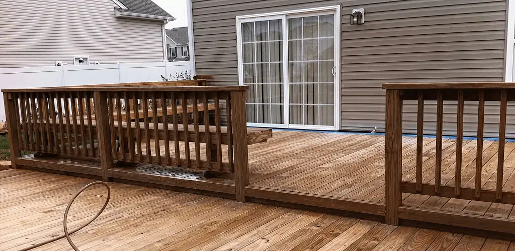 Deck sealing service protecting a backyard wood deck and railings in Evansville, IN