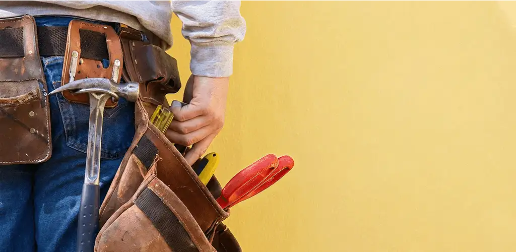 Handyman with tool belt ready for home repairs and maintenance in Evansville, IN