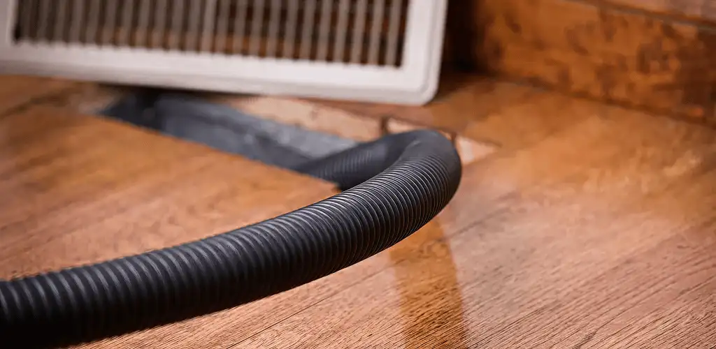 Air duct cleaning hose inserted into a floor vent for ductwork cleaning in Evansville, IN